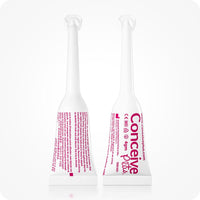 Image of two Conceive Plus try me size fertility lubricant applicators placed side by side on a white background. One applicator has its backside towards camera while the other one has its front side towards camera. White applicators pink branding and highlights info about manufacturer, website url, directions to apply, and quantity of the lube.