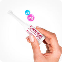 For Conceive Plus Try Me Size Fertility Lubricant Bundle, the image shows a single 4g pre-filled applicator being held between two fingers. White Conceive Plus applicator features pink branding, with calcium and magnesium ion icons displayed above on a clean white background.